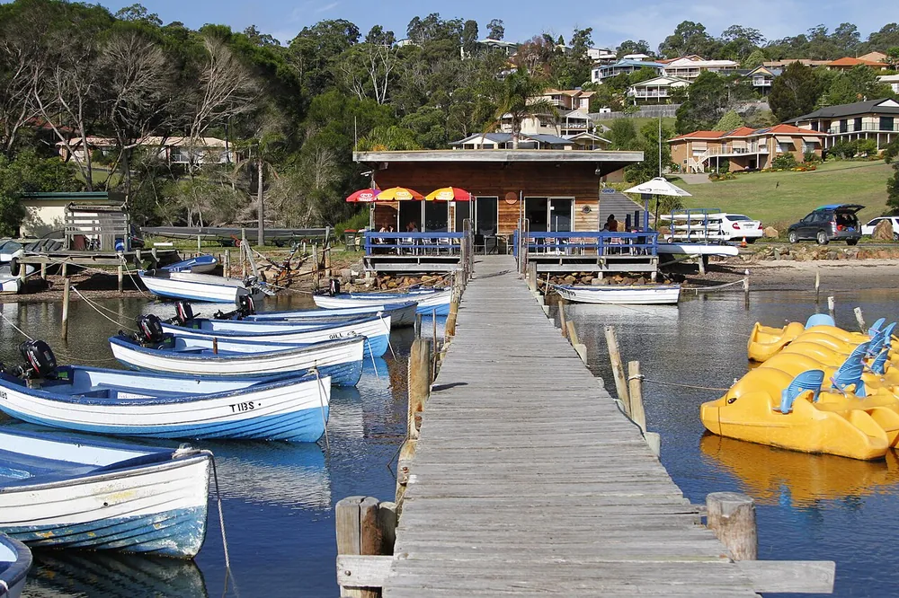 Houses stacked above the boatsheds on Merimbula's Top Lake